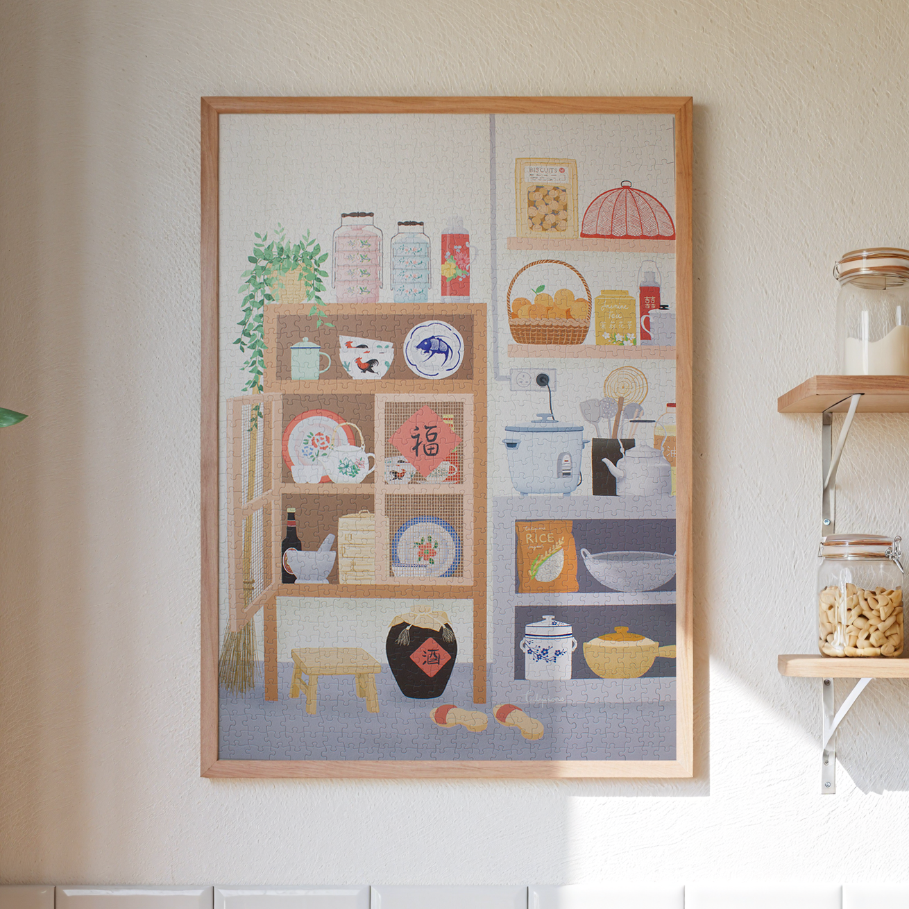 Framed artwork depicting a kitchen scene on a wall.