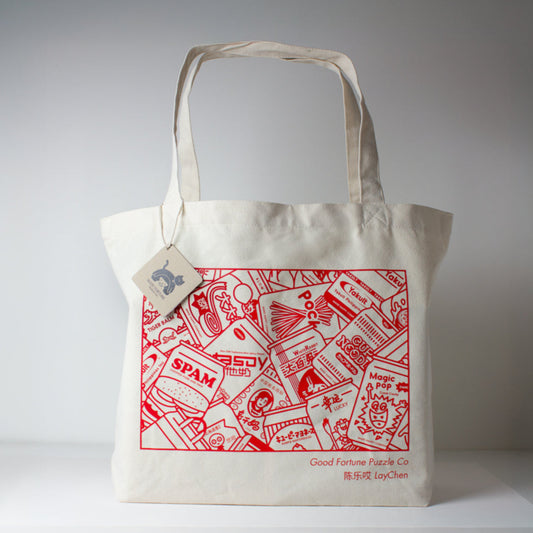 White tote bag with red graphic design on a canvas background