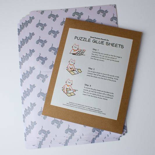 Puzzle glue sheets with instructions and a patterned paper on a white background